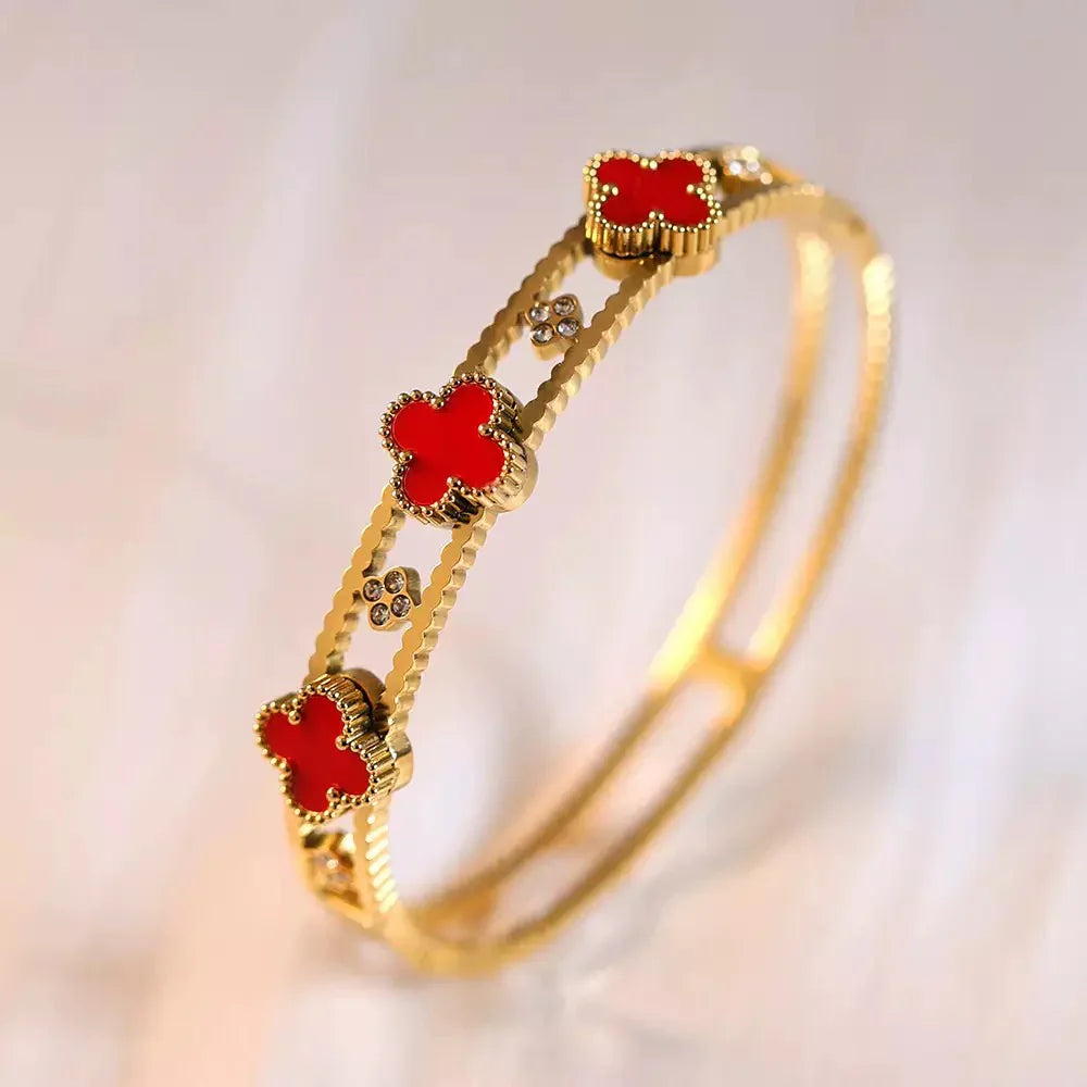 Gold plated bracelet with red clover design